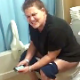 A fat girl is video-recorded taking a shit in two consecutive scenes. The first scene shows her grunting and pushing, then making audible plop sounds as her shit comes out. The second scene only shows her sitting there.